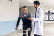 doctor or nurse helping Senior man to walk at nursing home with walker. Doctor or  nurse helping old elderly  man grandfather to walk using walker equipment