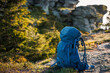Hiking backpack during trek in mountains. Hike and trekking outdoor equipment