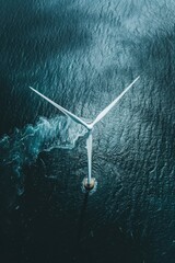 Poster - A wind turbine standing in the middle of a body of water. Suitable for environmental and renewable energy concepts