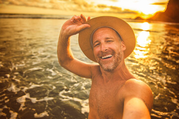 Wall Mural - nice man taking selfie portrait on beach