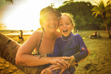 Wall Mural - nice woman having great time on beach with his daughter