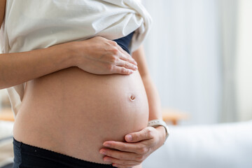 Poster - Pregnant woman hold her belly close up