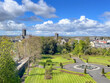 The grounds of Kilkenny Castle in Kilkenny, Ireland on a spring day with a blue sky and white clouds. 