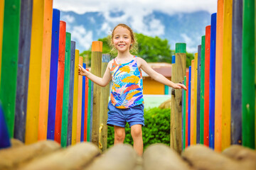 Wall Mural - Active little girl having fun on playground