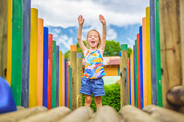 Wall Mural - Active little girl having fun on playground