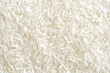 © Emmy Ljs - Close up white rice grain texture background of uncooked rice.