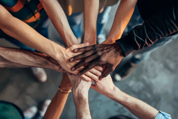 Group of young people meditating during yoga retreat,  Conceptual symbol of multiracial human hands making a circle