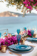 A beautifully decorated outdoor table with bouquets of flowers, luxury tableware and cutlery