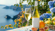 White wine in glass bottle with blank label, peaches and flowers in a ceramic pot on the background of the Mediterranean landscape