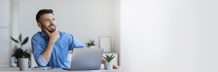 Pensive businessman sitting at workplace in modern office, thinking about new business idea, touching chin and looking aside with smile, free space