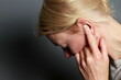 suffering from deafness and hearing loss on grey background with people stock image stock photo
