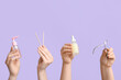 © Pixel-Shot - Female hands with bottles of cuticle oil, nail cutter and orange sticks on lilac background