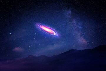 Wall Mural - Beautiful spiral galaxy in starry sky over mountains