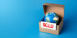 Earth globe in a package for sale, planet sold, symbolic concept of the usual business of selling planetary resources with excess, leading to environmental issue and ecological catastrophe