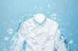 White shirt washed in water with soap bubbles on clean background