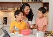 © Fernanda - Mom with her Hispanic children preparing a cake at home - family time - happy single mother with her children - Latin lifestyle