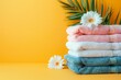 Stack of Towels on Yellow Background