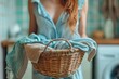 Woman Holding Basket of Clothes in Front of Washing Machine
