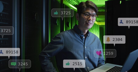 Poster - Image of social media icons over asian male engineer using laptop at server room