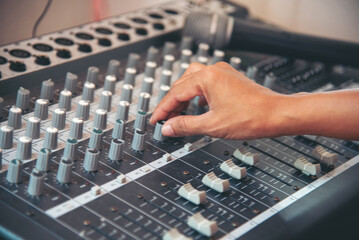 Wall Mural - Production sound engineer hands working on recording studio mixing voice control. Expert adjusting volume equalizer voice, mixing console DJ sound engineering. Producer remix tune music sound record