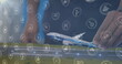 Image of digital icons over mid section of a woman flying a airplane model at office