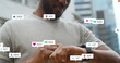 Image of social media icons with numbers over african american man using smartwatch