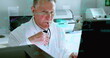 Image of medical data processing on caucasian senior male scientist using computer at laboratory