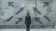 Businesswoman contemplating multiple arrows on a concrete wall, symbolizing decision making and strategy. Generative AI
