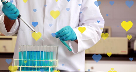 Poster - image of yellow and blue hearts falling over midsection of biracial male lab worker