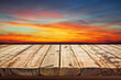 Wooden table on sky background and sunset light	