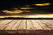 Wooden table on sky background and sunset light	