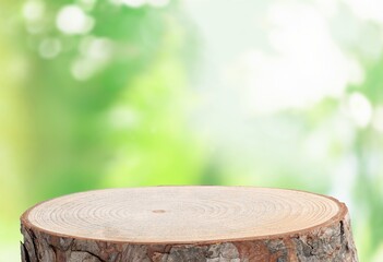 Poster - Wood tabletop round podium in outdoors background.