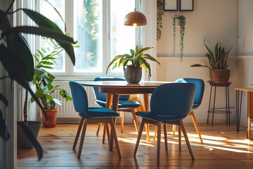 Wall Mural - Round wooden dining table and blue chairs. Scandinavian, mid-century home interior design of modern dining room.