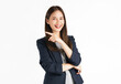 Cheerful Asian businesswoman as she points to the side with her hand, isolated on a white background.