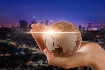 Canvas Print - Globe Earth in human hands at night city