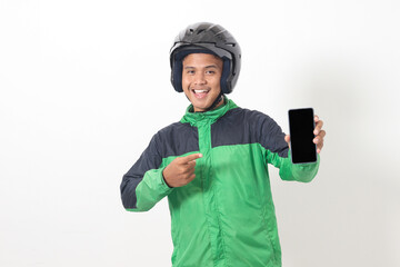 Wall Mural - Portrait of Asian online taxi driver wearing green jacket and helmet showing and presenting blank screen mobile phone. Isolated image on white background