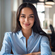 © VISUAL BACKGROUND - Beautiful young woman in blue shirt smiling at camera.