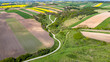 Grodzisko Stradow medieval settlement and curvy countryside road in Ponidzie region of Poland. Drone view