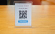 Shop or store accepted digital pay without money , plastic tag on wooden table for scan qr code.