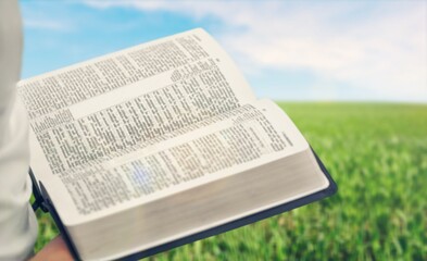 Canvas Print - Open bible in human hands outdoor