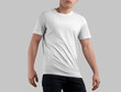 White t-shirt mockup on athletic guy in black jeans, summer crew neck shirt for design, pattern, branding, front view.
