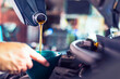 Close-up photo of a mechanic pouring fresh oil into a car engine during routine maintenance.