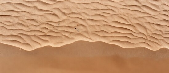 Aufkleber - Top view of a sandy beach featuring a textured sand surface that serves as an ideal background for a copy space image