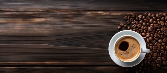 Poster - A top view of a cup of coffee and a bean on a black wooden table creates a captivating copy space image
