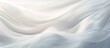 © vxnaghiyev - A serene backdrop of white fabric with gentle abstract waves creating an ethereal ambiance Perfect as a copy space image