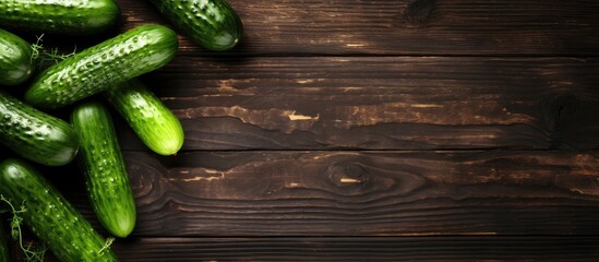 Aufkleber - A top down view of fresh cucumbers displayed on a rustic wooden table providing ample space for text and creating a visually appealing copy space image