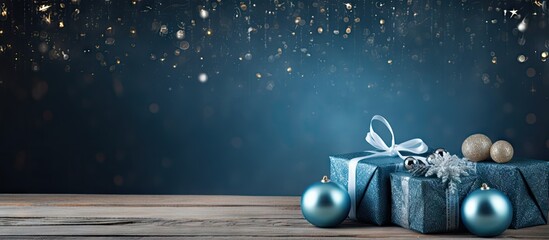 Poster - A blue wooden background with a festive touch of Christmas gifts and decorations Copy space image