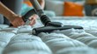 Person in White Gloves Cleaning Bed