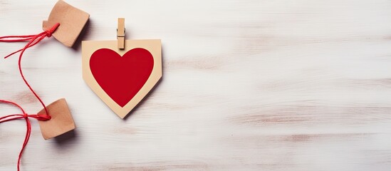 Aufkleber - Valentine s day design with a heart shaped wooden clothespin and a wooden photo frame on a gray wall creating a perfect copy space image 115 characters