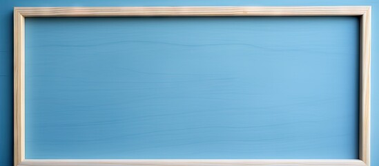 Poster - A close up of an empty wooden frame on a blue background providing copy space for text The photo is of high quality